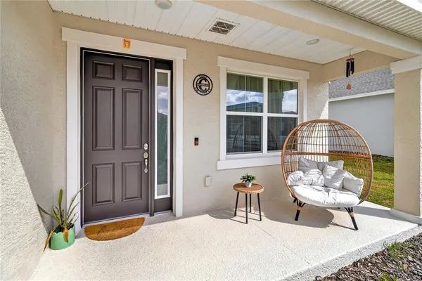 a bedroom with a bed and a potted plant