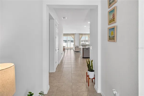 a hallway with a dining table & chairs in it