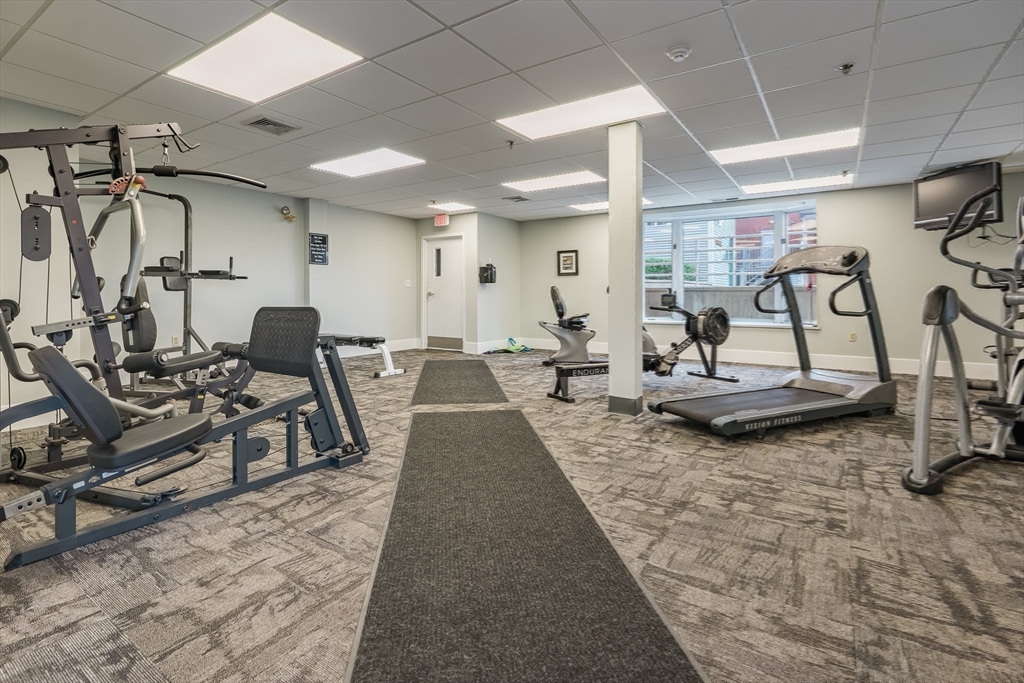 45 Main Street, Unit 112 Wareham, MA 02571 - Photo 23 of 30 a living room with lots of furniture and gym equipment