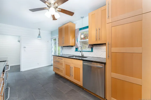 a kitchen with stainless steel appliances granite countertop cabinets and a refrigerator