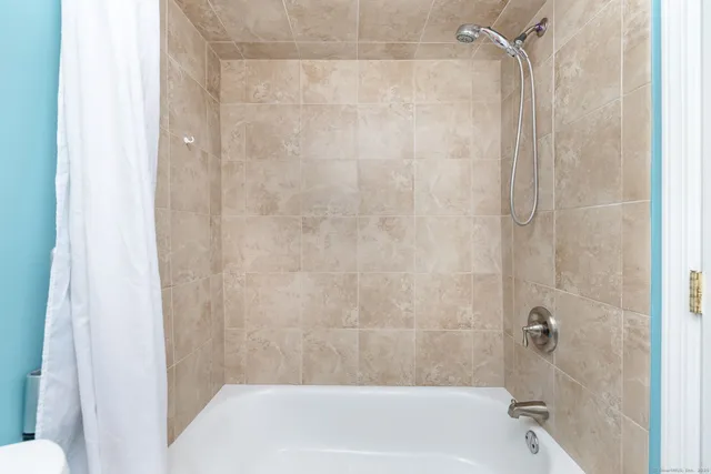 a bathroom with a shower and a bath tub