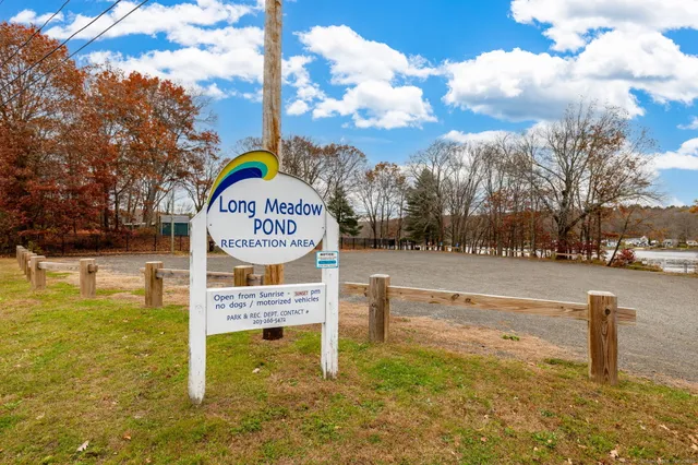 a view of a lake with a table and chairs