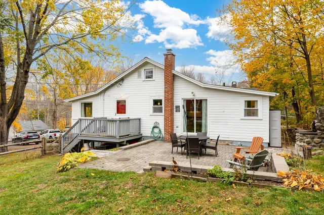 a view of backyard of house with outdoor seating