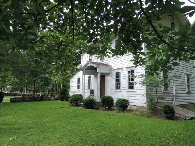 1053 Ridgefield Road Wilton, CT 06897 - Photo 1 of 1 a front view of a house with a garden