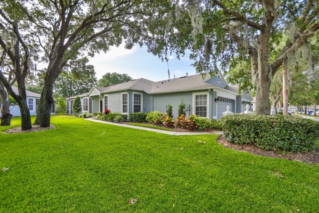 6040 Sandhill Ridge Drive Lithia, FL 33547 - Photo 1 of 1 a front view of a house with a garden
