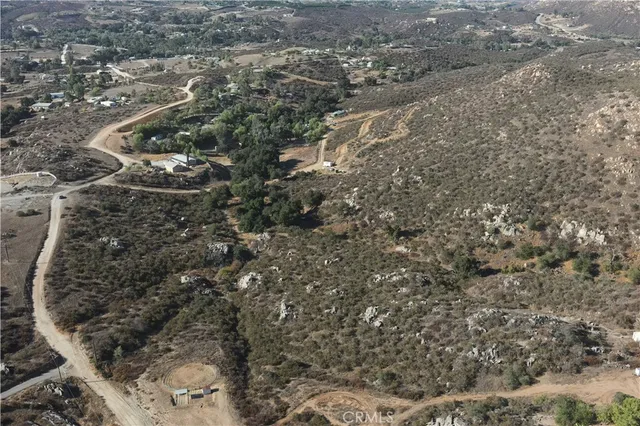 a view of a yard with wooden fence
