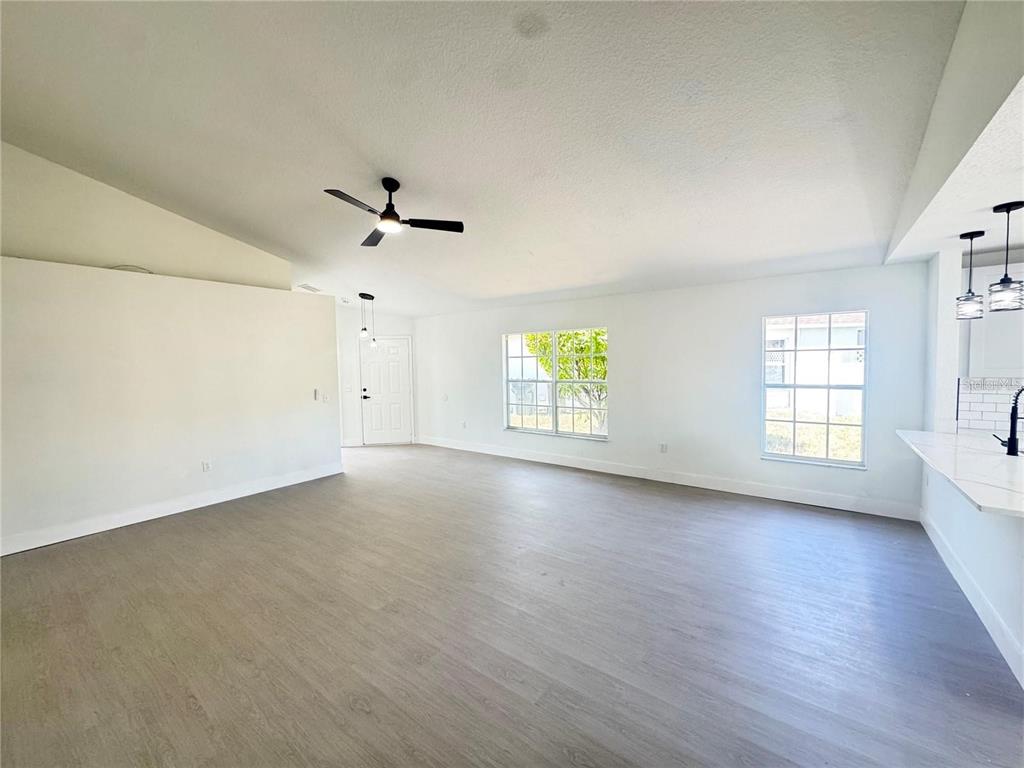 207 High Ridge Drive Davenport, FL 33837 - Photo 12 of 33 an empty room with wooden floor and windows