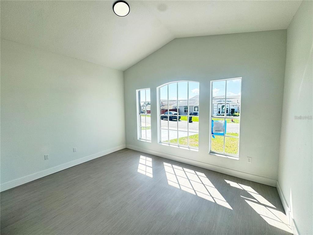 207 High Ridge Drive Davenport, FL 33837 - Photo 17 of 33 a view of empty room with wooden floor and fan