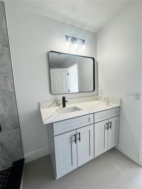 207 High Ridge Drive Davenport, FL 33837 - Photo 20 of 33 a bathroom with a double vanity sink and a mirror