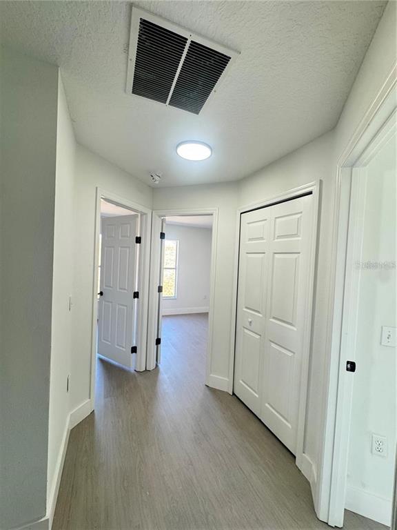 207 High Ridge Drive Davenport, FL 33837 - Photo 23 of 33 an empty room with wooden floor and closet