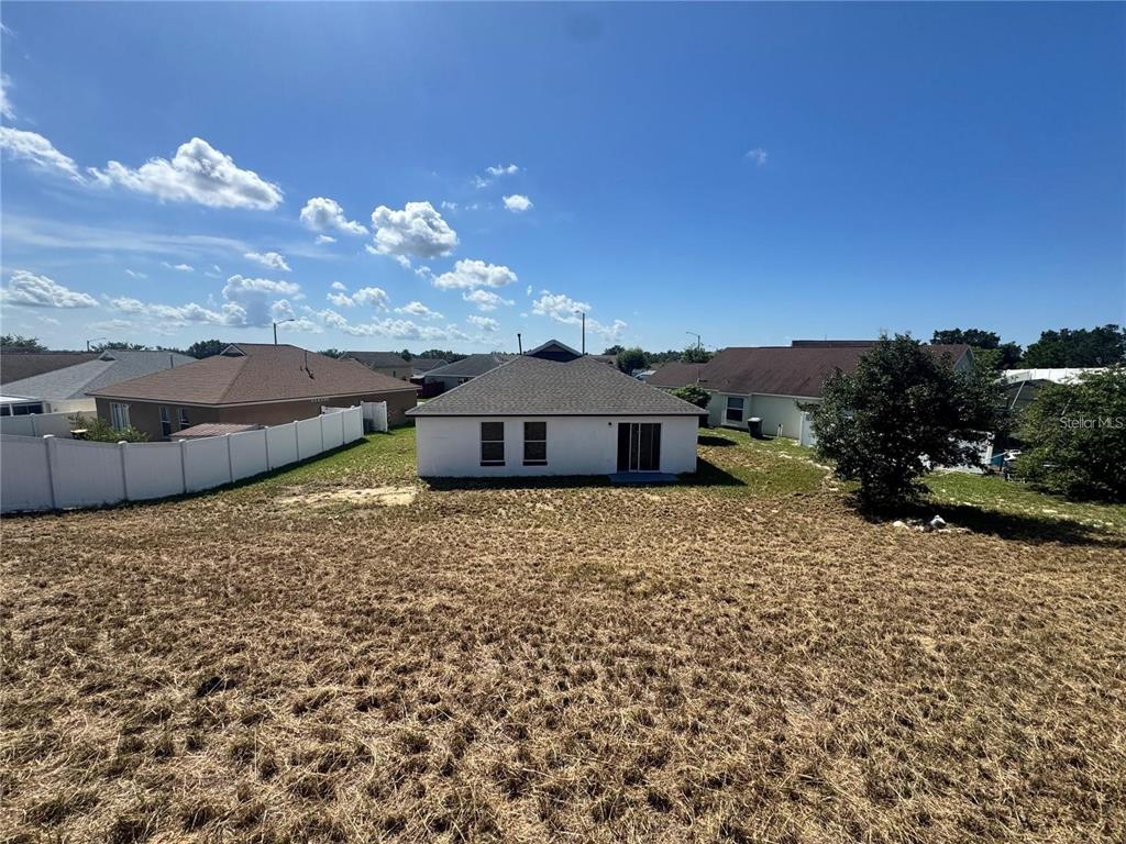 207 High Ridge Drive Davenport, FL 33837 - Photo 30 of 33 a view of a house with a yard