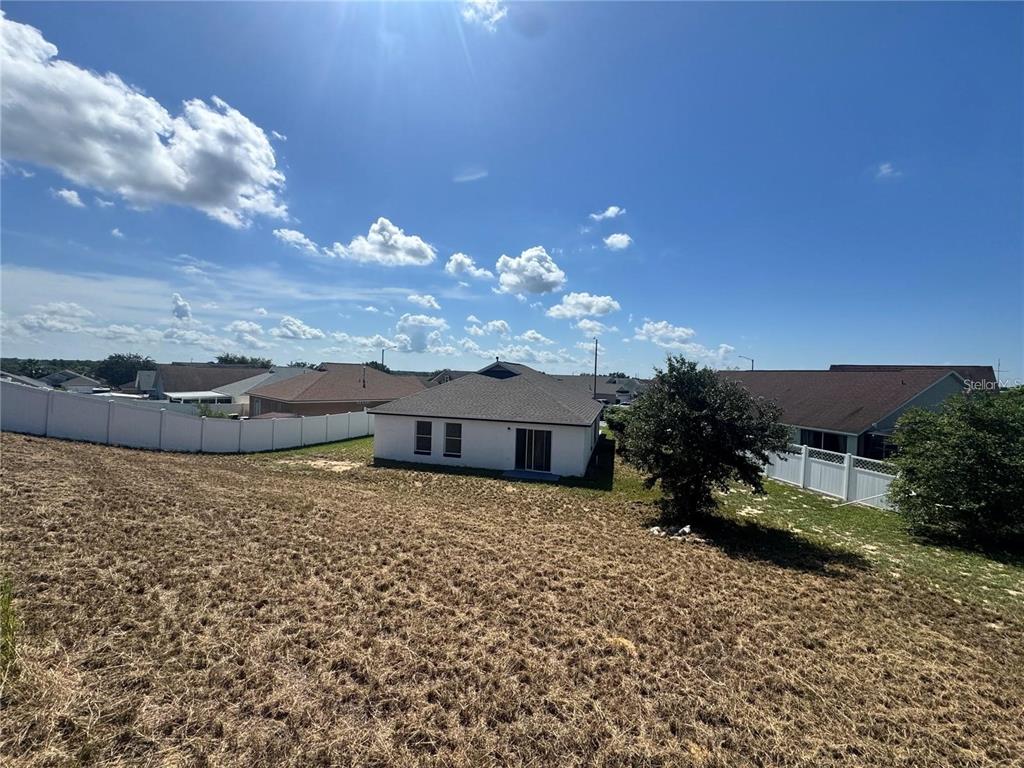 207 High Ridge Drive Davenport, FL 33837 - Photo 31 of 33 a view of a house with a yard