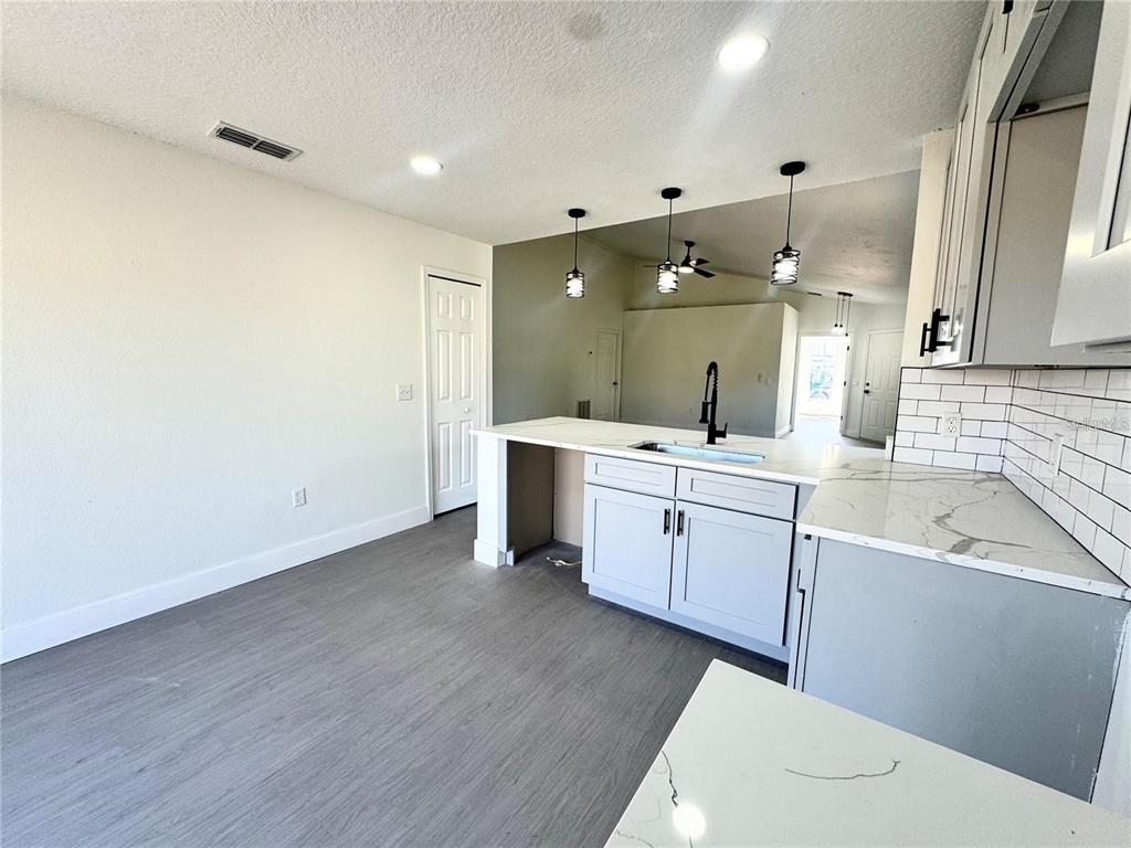 207 High Ridge Drive Davenport, FL 33837 - Photo 8 of 33 a large bathroom with a sink a large mirror and vanity