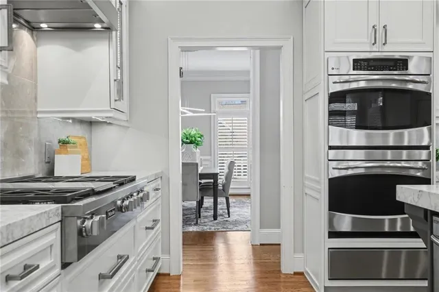 a living room with furniture and floor to ceiling windows