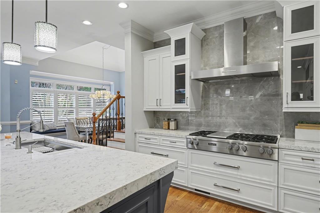 225 Farmbrooke Court Atlanta, GA 30350 - Photo 3 of 84 a kitchen with stainless steel appliances granite countertop a stove a sink and a white cabinets