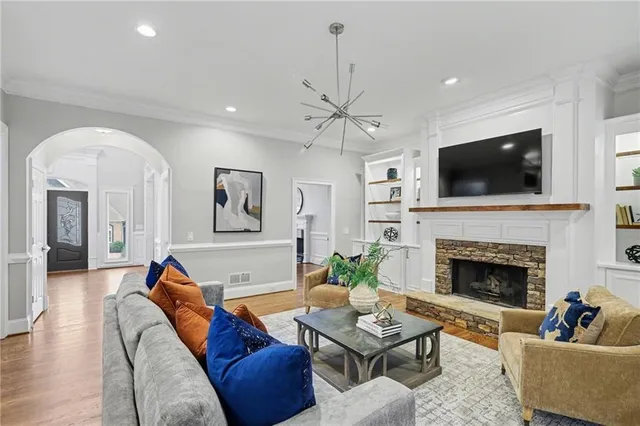 a large kitchen with kitchen island a stove a sink a center island and wooden floor