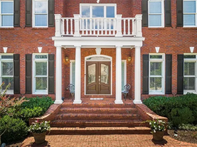 a view of a kitchen with wooden floor and electronic appliances