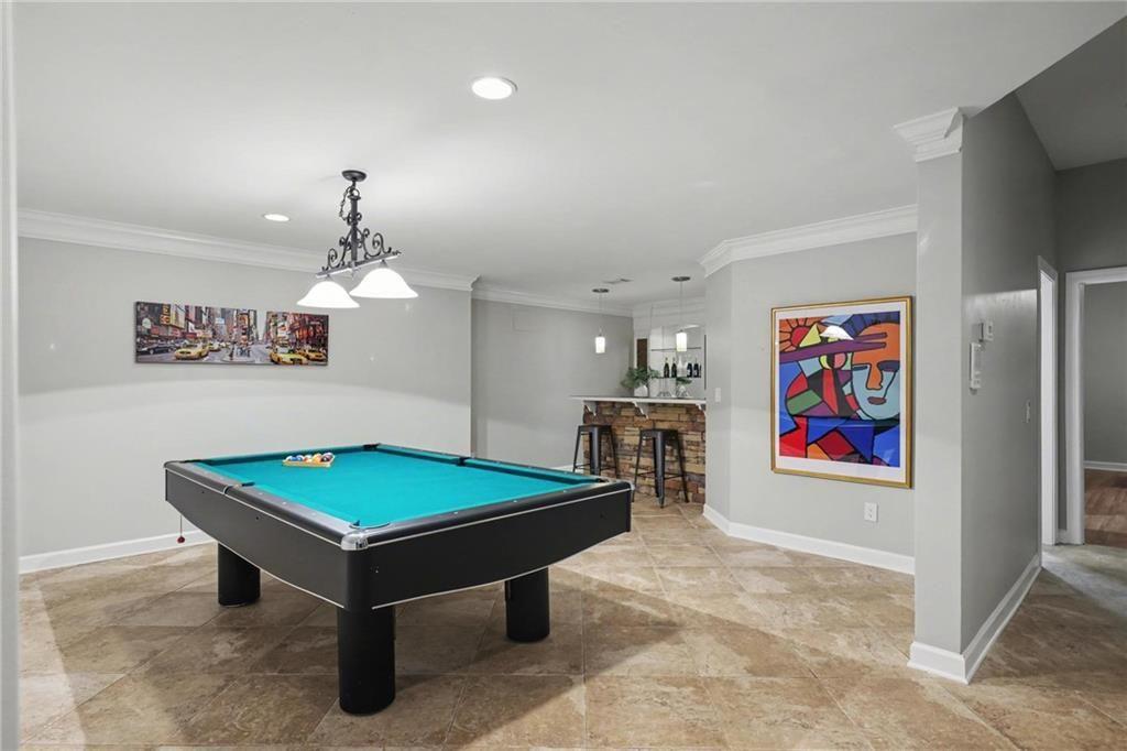 225 Farmbrooke Court Atlanta, GA 30350 - Photo 64 of 84 a room with pool table and paintings on the wall