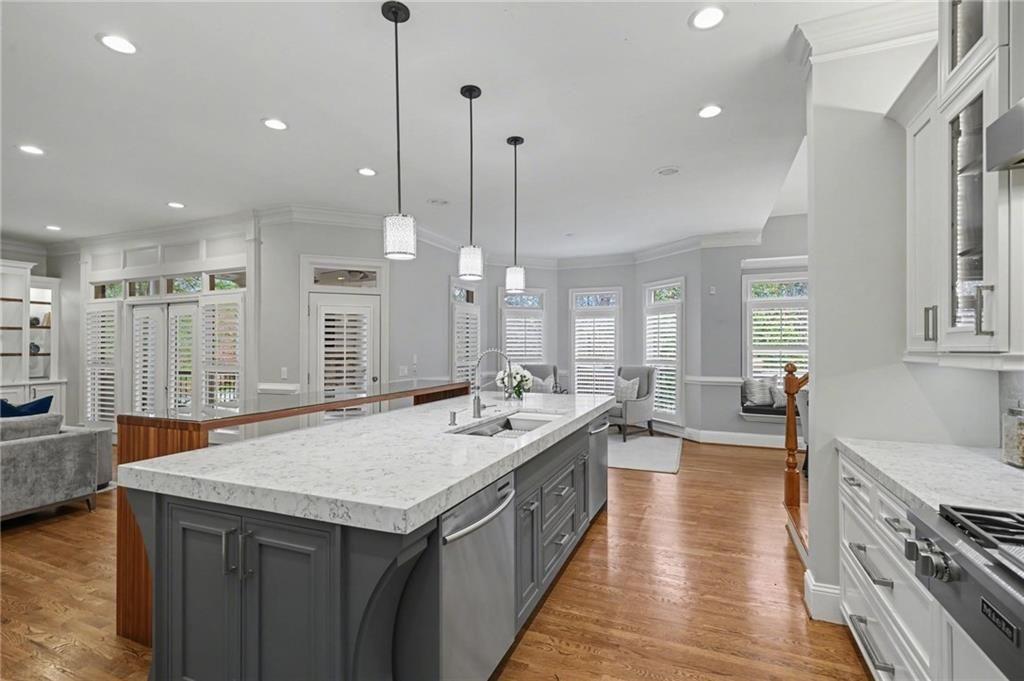 225 Farmbrooke Court Atlanta, GA 30350 - Photo 7 of 84 a large kitchen with kitchen island a stove a sink a center island and wooden floor
