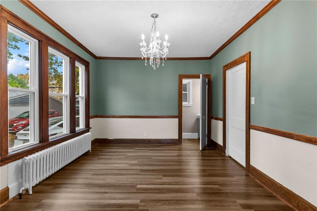 895 Alcoma Street Sharon, PA 16146 - Photo 13 of 41 a view of an empty room with wooden floor and a window