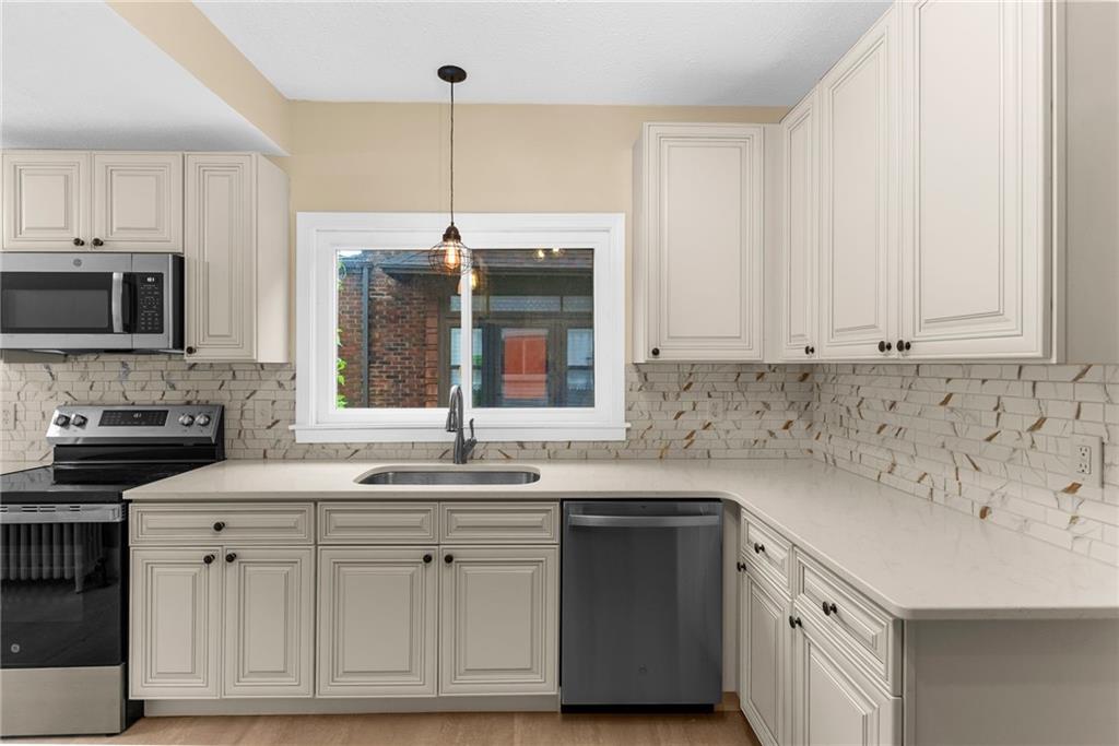 895 Alcoma Street Sharon, PA 16146 - Photo 16 of 41 a kitchen with white cabinets and sink