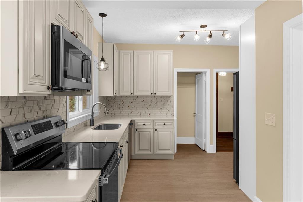 895 Alcoma Street Sharon, PA 16146 - Photo 18 of 41 a kitchen with cabinets and stainless steel appliances