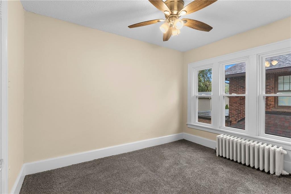 895 Alcoma Street Sharon, PA 16146 - Photo 25 of 41 an empty room with windows and fan