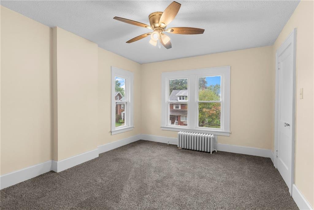 895 Alcoma Street Sharon, PA 16146 - Photo 26 of 41 an empty room with windows and fan