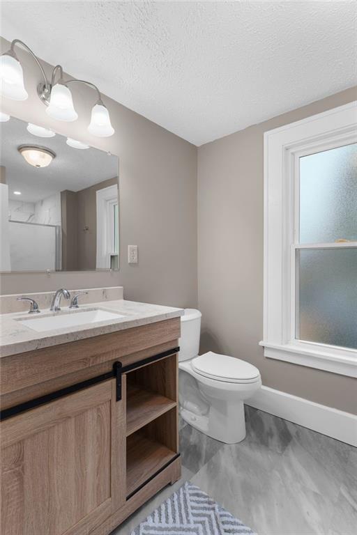 895 Alcoma Street Sharon, PA 16146 - Photo 29 of 41 a bathroom with a granite countertop sink a toilet and a mirror