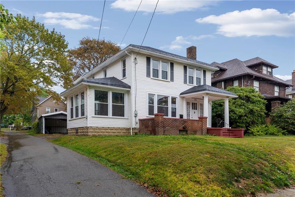 895 Alcoma Street Sharon, PA 16146 - Photo 3 of 41 a front view of a house with a yard table and chairs