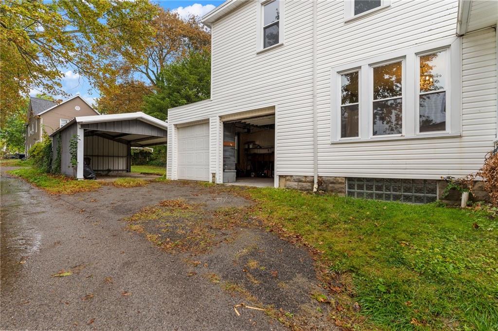 895 Alcoma Street Sharon, PA 16146 - Photo 6 of 41 a view of a house with a yard and garage