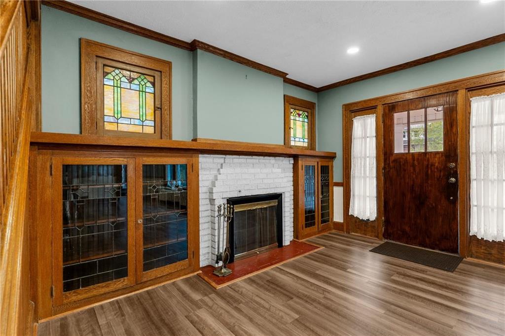 895 Alcoma Street Sharon, PA 16146 - Photo 9 of 41 an empty room with wooden floor fireplace and windows