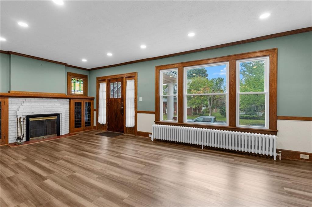 895 Alcoma Street Sharon, PA 16146 - Photo 10 of 41 a view of an empty room with a fireplace and a window