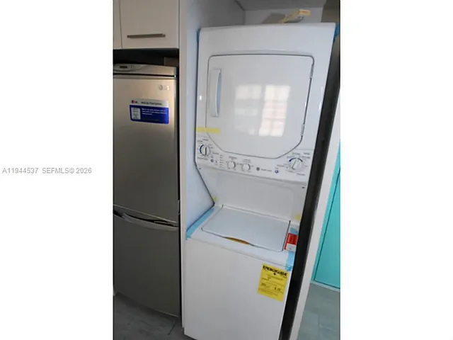 a close view of a utility room with dryer and washer