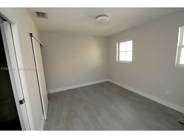 a view of an empty room and a window