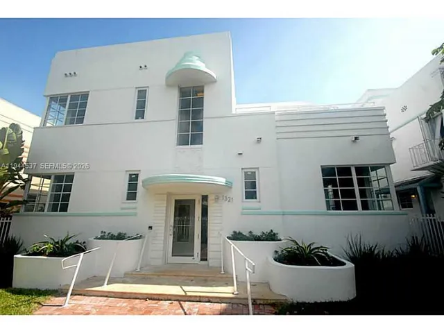 a view of a house with potted plants