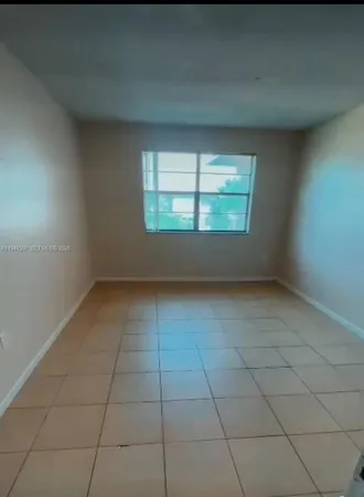 an empty room with a empty space and window