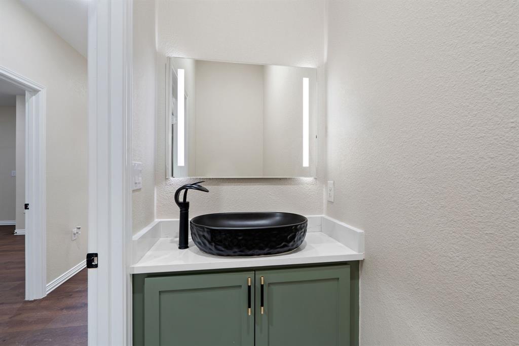 2514 Carpenter Avenue Dallas, TX 75215 - Photo 11 of 24 a bathroom with a sink and a mirror