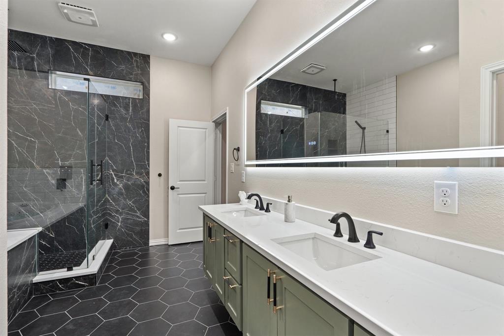 2514 Carpenter Avenue Dallas, TX 75215 - Photo 15 of 24 a bathroom with a double vanity sink mirror and shower