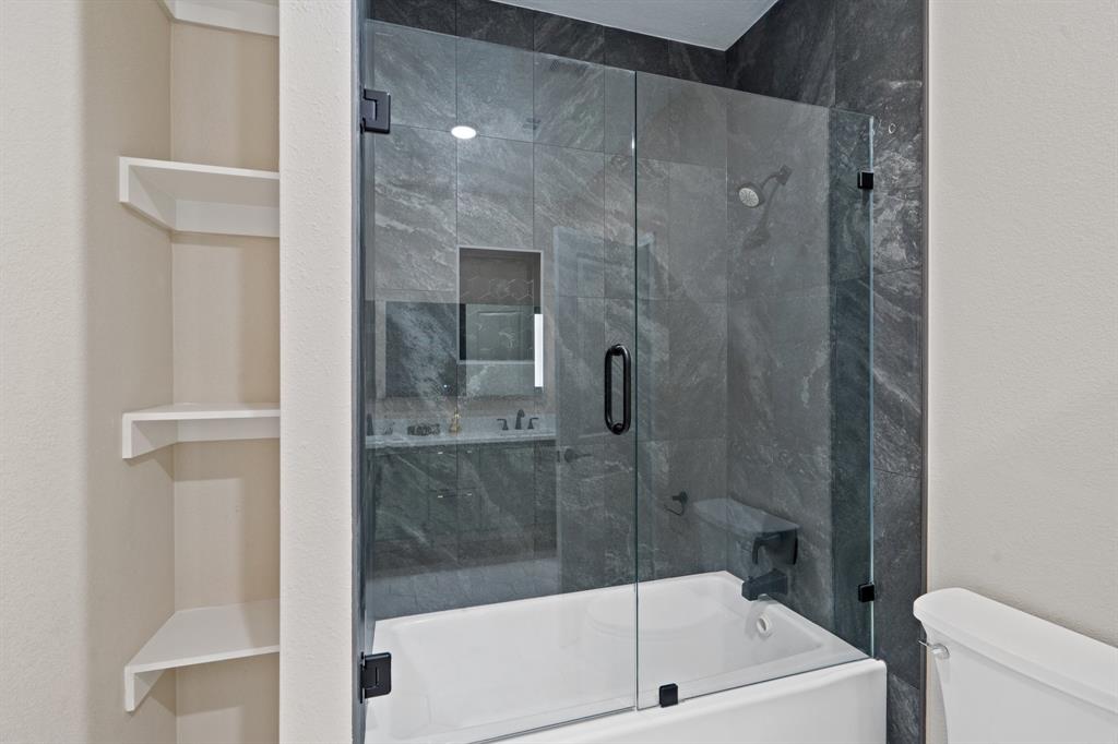 2514 Carpenter Avenue Dallas, TX 75215 - Photo 20 of 24 a bathroom with a bathtub and a shower