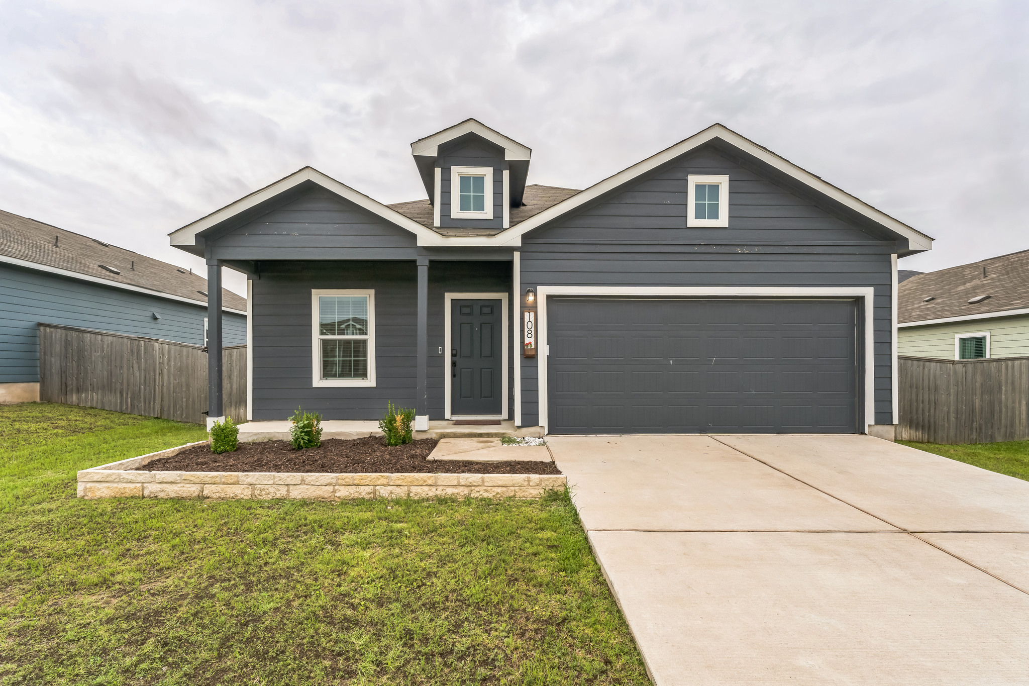 a front view of a house with garden