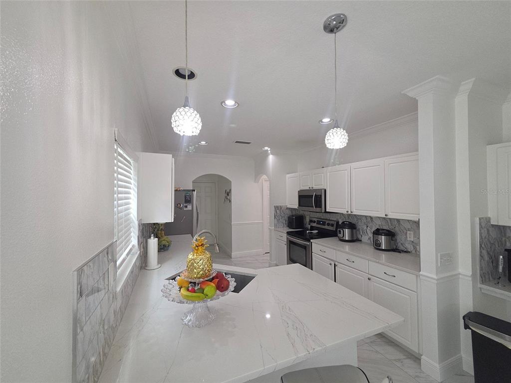 4162 Day Bridge Place Ellenton, FL 34222 - Photo 13 of 49 a kitchen that has a lot of cabinets a sink and appliances in it