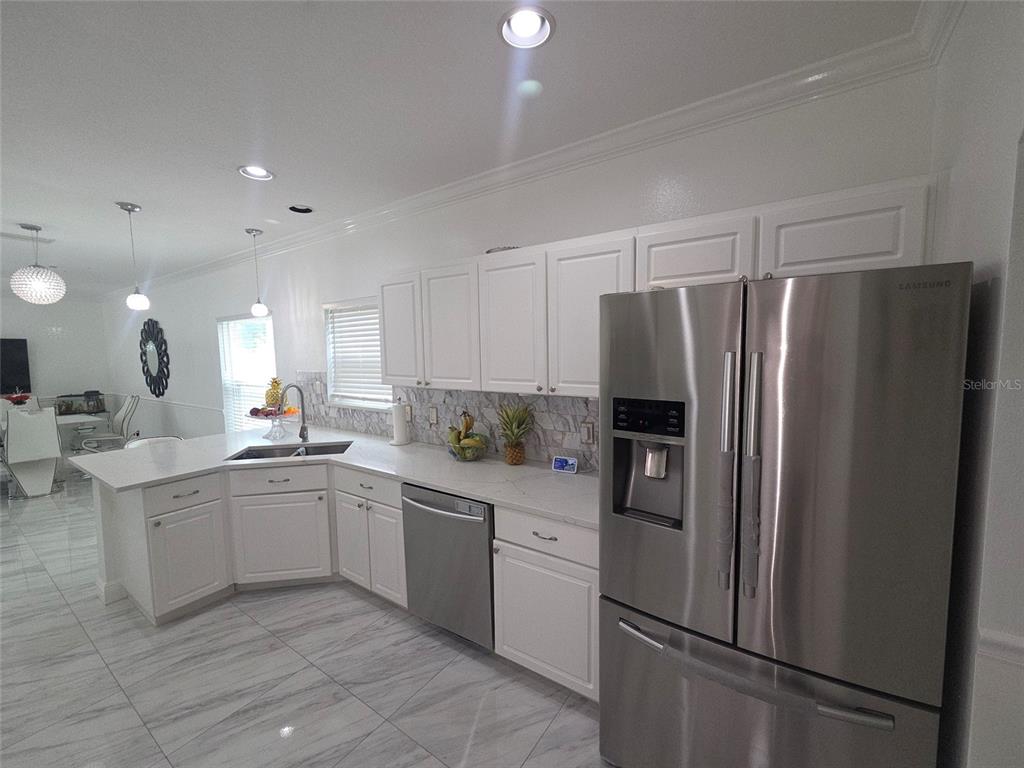 4162 Day Bridge Place Ellenton, FL 34222 - Photo 14 of 49 a kitchen with a refrigerator sink and cabinets