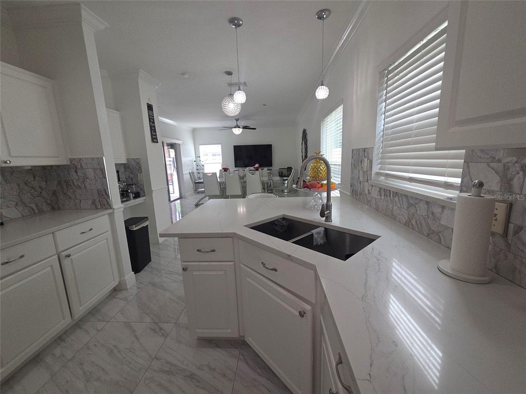 4162 Day Bridge Place Ellenton, FL 34222 - Photo 15 of 49 a kitchen with white cabinets and sink