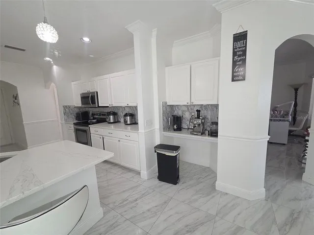 a kitchen with a refrigerator and a stove top oven