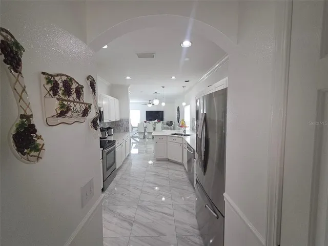 a kitchen with a refrigerator and a sink