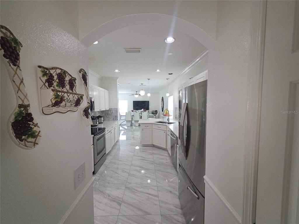 4162 Day Bridge Place Ellenton, FL 34222 - Photo 18 of 49 a kitchen with a refrigerator and a sink