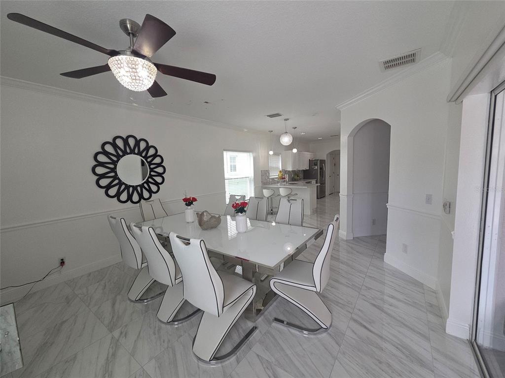 4162 Day Bridge Place Ellenton, FL 34222 - Photo 19 of 49 a dining room with furniture and a chandelier