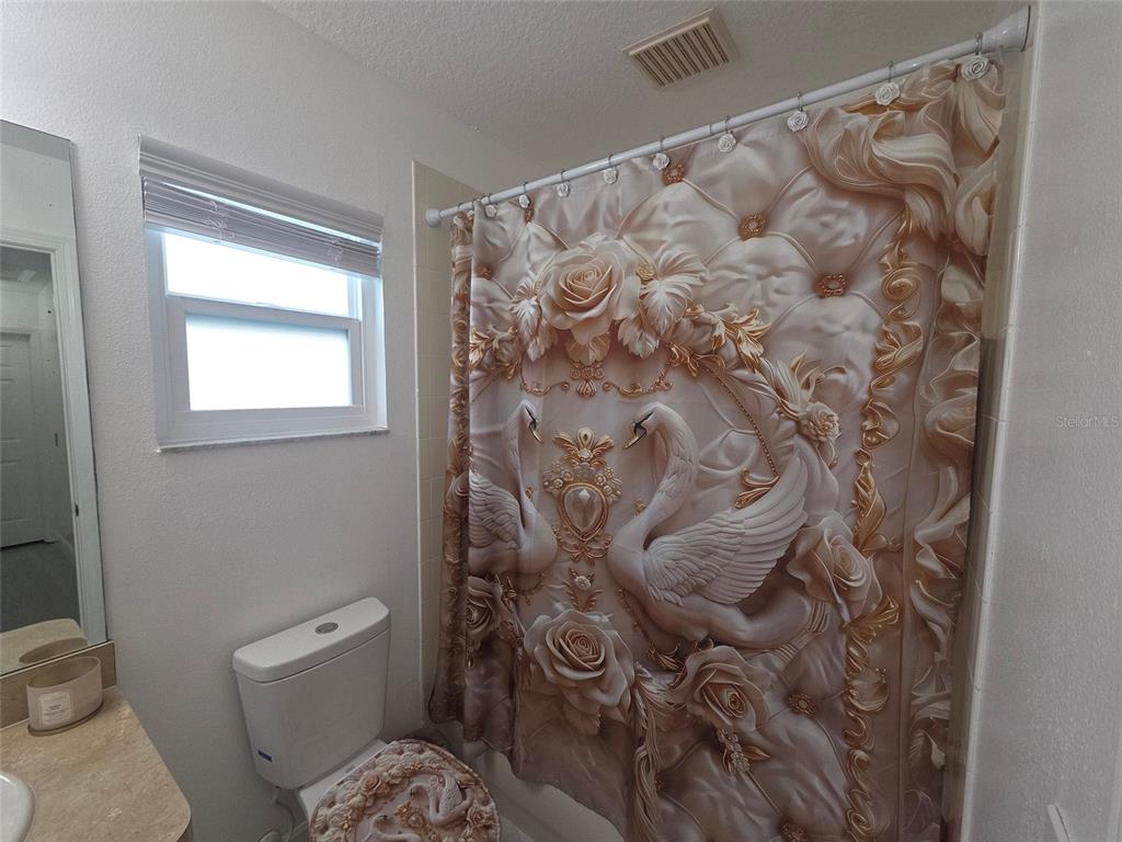 4162 Day Bridge Place Ellenton, FL 34222 - Photo 43 of 49 a bathroom with a toilet and a shower curtain