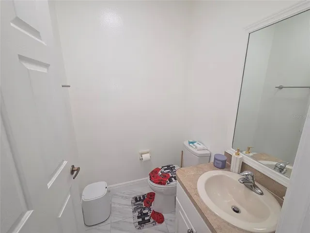 a bathroom with a sink toilet and vanity